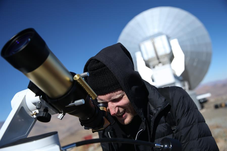 Un hombre observa el sol a través de un telescopio horas antes de que comience el eclipse solar total, este martes en el Observatorio de La Silla, situado en la región de Coquimbo (Chile). 