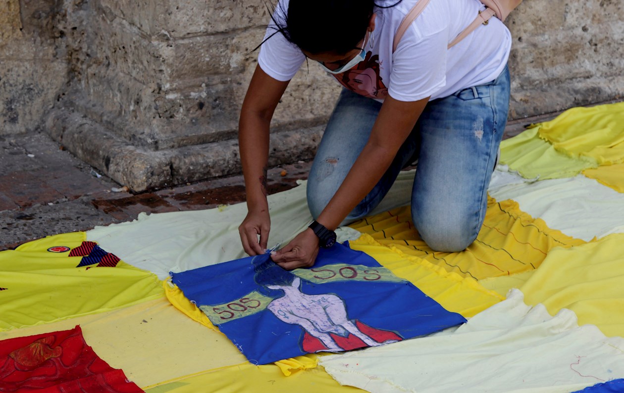 Artistas de la ciudad tejen con retales de tela una bandera nacional durante una nueva jornada de paro nacional hoy, en Cartagena de Indias (Colombia).