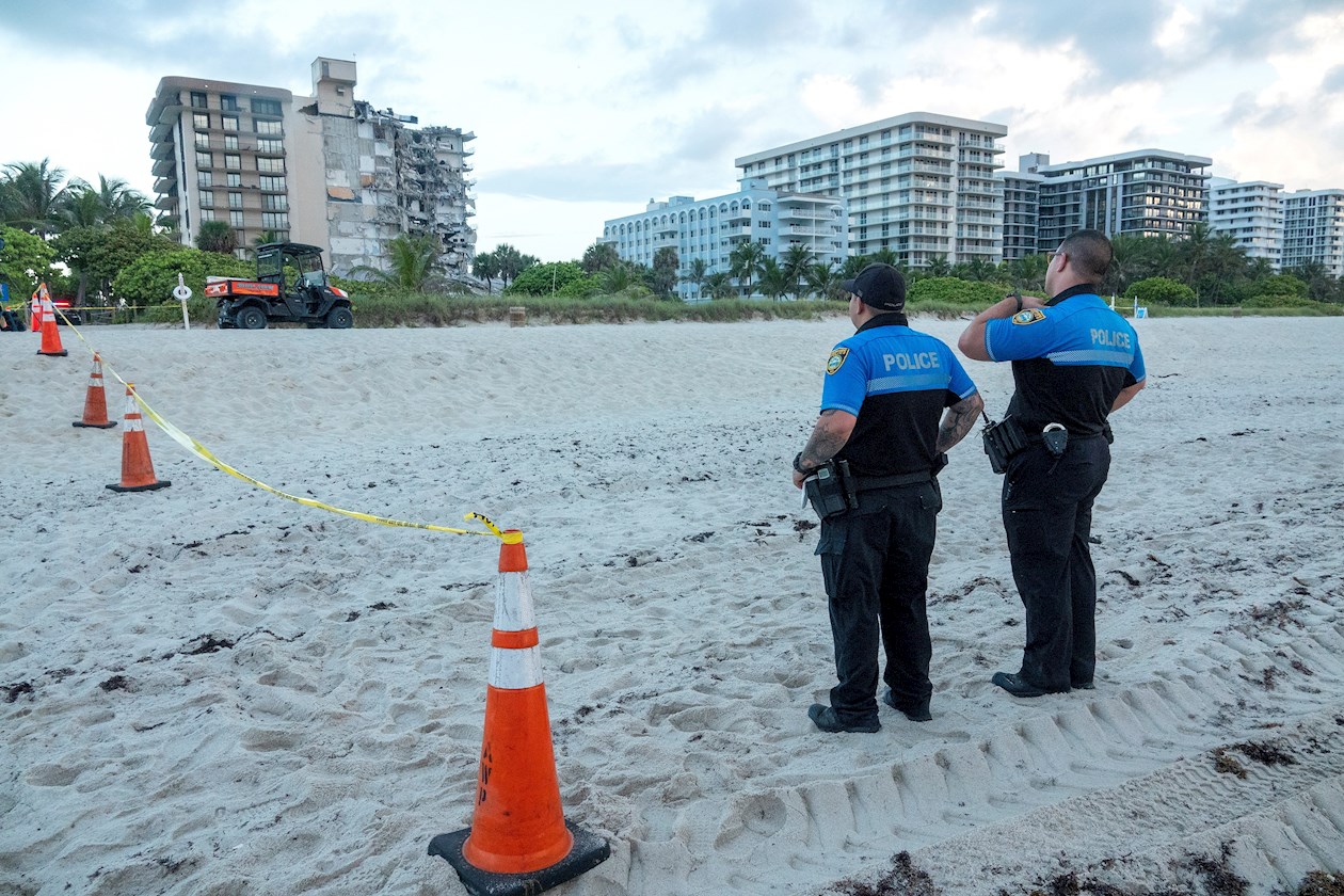 Dos policías cuidan la zona cercana al edificio que se derrumbó parcialmente en Miami Beach.