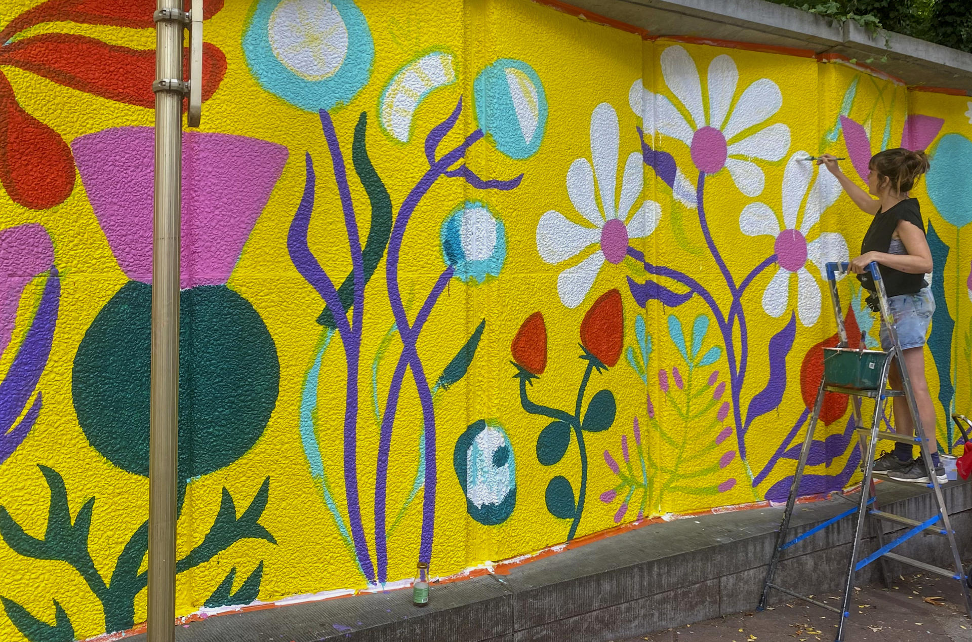 Artista pinta un mural en Bruselas.