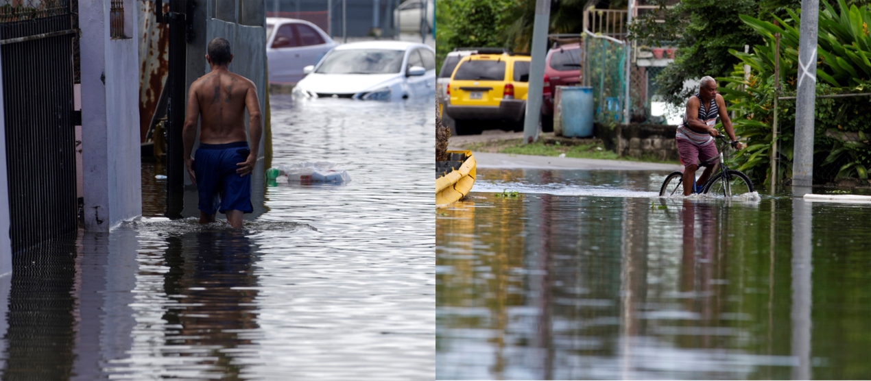 Un hombre a pie y otro en bicicleta cruza una calle inundada debido a las intensas lluvias registradas el pasado fin de semana, hoy, en Cataño (Puerto Rico). 