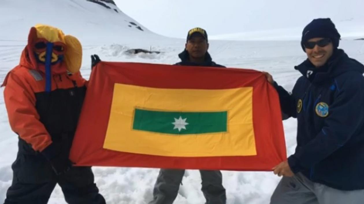 El suboficial primero Joel Calzado junto a Pedro Pallares y la bandera de Barranquilla en la Antártida