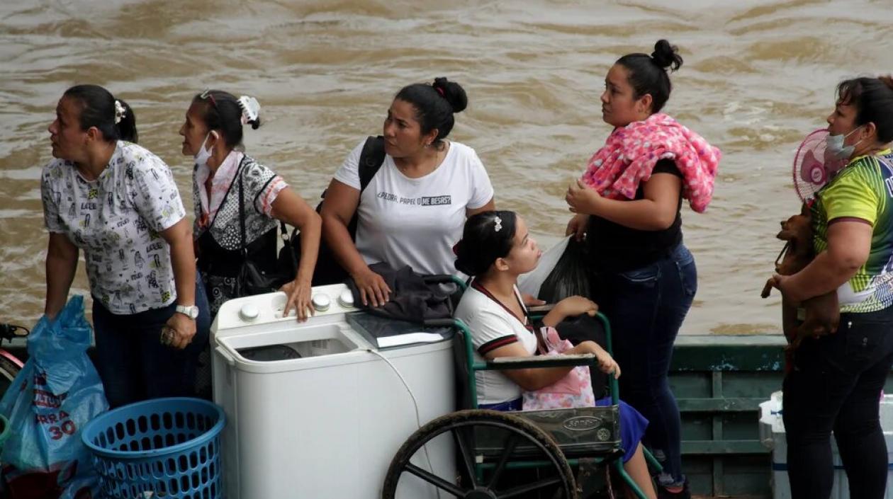 Migrantes venezolanos cruzan en botes hacia Colombia.