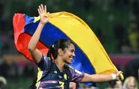 La jugadora colombiana Daniela Arias celebra, con la bandera de su país este martes luego de pasar a cuartos de final