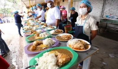 Voluntarios esperan con comidas calientes a los beneficiarios que llegan diariamente.
