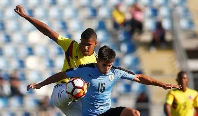 Jaime Alvarado marca a un jugador de la Selección de Uruguay. 