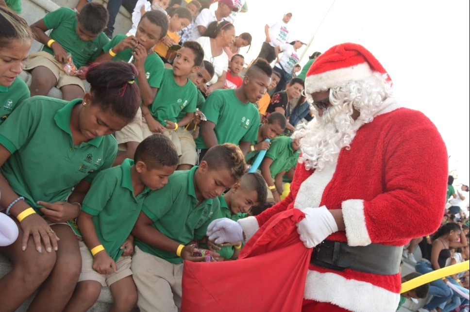 Papá Noel repartiendo dulces a los niños.