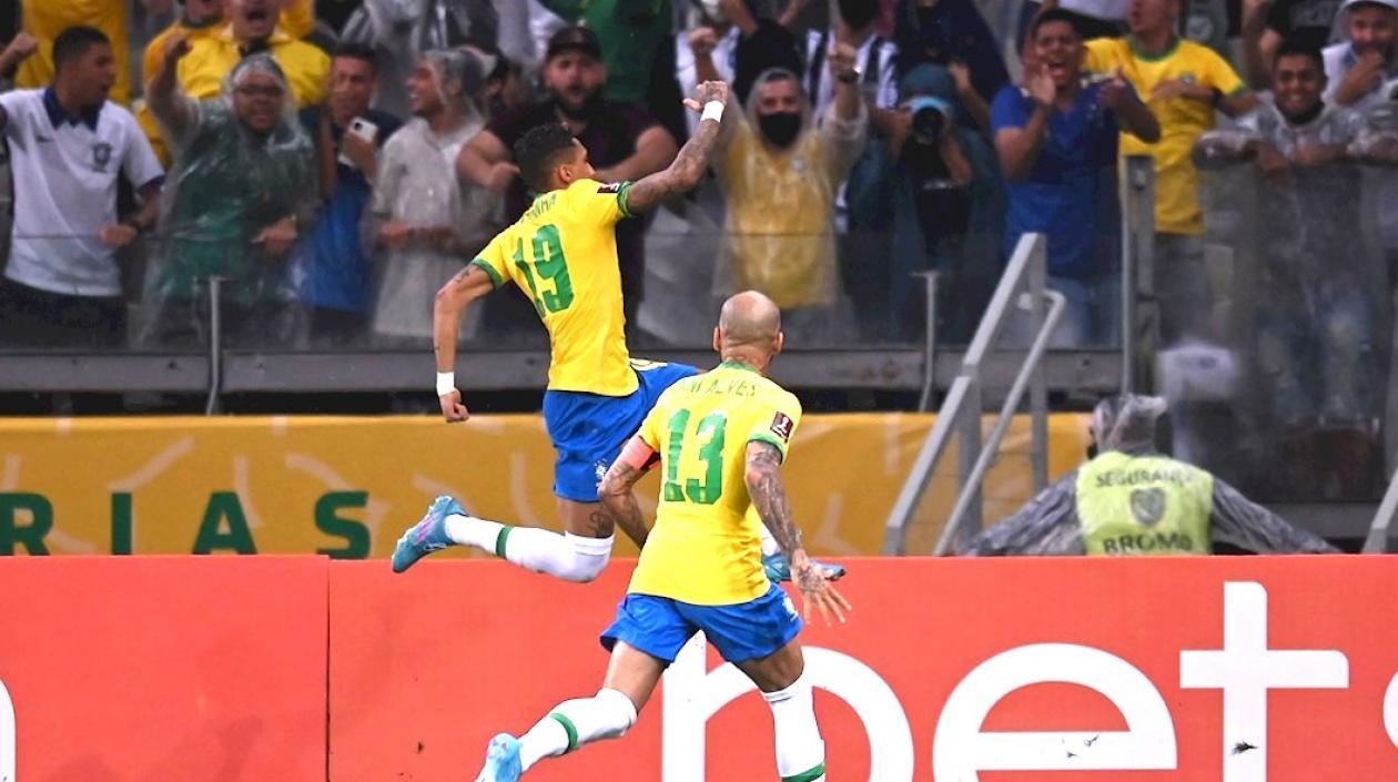 Raphinha celebrando su gol con Dani Alves.