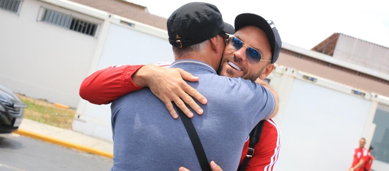 Sebastián Viera se abraza con su padre, Mario, que fue a recibirlo al aeropuerto de Trujillo.