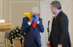 El Presidente Duque rindió homenaje a José Néstor Pékerman, quien besa la bandera, por su labor al frente de la Selección Colombia.