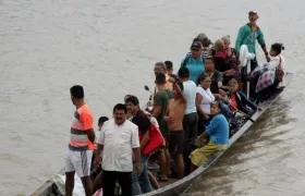 En botes cruzan desde La Victoria, en Venezuela, hasta Arauquita, en Colombia.