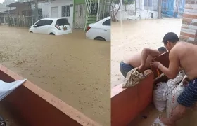 Habitantes tratando de evacuar las aguas de sus viviendas.