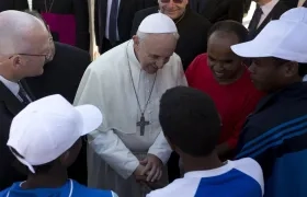 El Papa Francisco conversando con un grupo de migrantes.