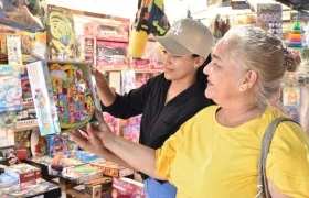 Dos clientes observan los juguetes en uno de los puestos ubicados en la Feria del Juguete