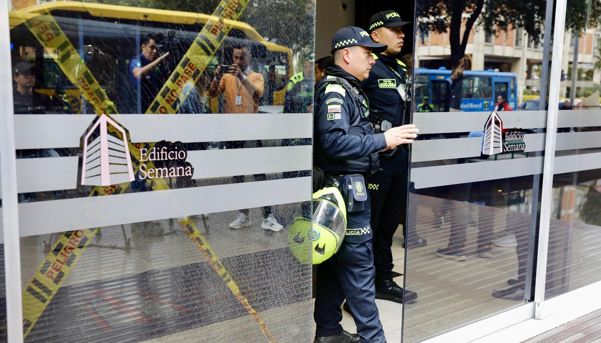 Integrantes de la Policía permanecen en la entrada del edificio donde funciona la revista Semana.