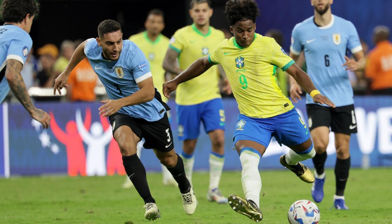 El brasileño Endrick alista un remate hacia la portería de Uruguay ante la marca de Sebastián Cáceres. 