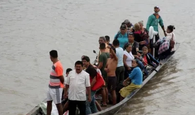 En botes cruzan desde La Victoria, en Venezuela, hasta Arauquita, en Colombia.