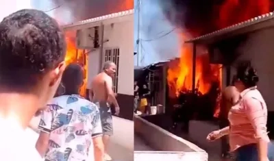 Vecinos de San Vicente observan las llamas que salen de una vivienda en la calle 50C con carrera 2D